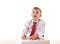 Handsome schoolboy is looking at camera and leaning on the table while drawing