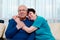 handsome senior couple. husband with glasses and wife embraces her,