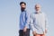 Handsome senior men in blue shirt. Male multi generation family walking. Portrait of two bearded men. Happy grandfather