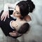 Handsome, sensual groom kissing beautiful bride on the neck closeup, view from above