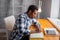 Handsome serious African guy making notes in the bedroom