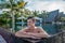 Handsome sexy boy smiling in the swimming pool at tropical island luxury resort