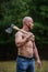 Handsome shirtless man muscular body. Bodybuilding sport concept. Forester with axe. Last man on planet. Sexy macho bare