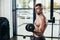 handsome shirtless sweaty sportsman training with dumbbells