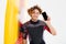 Handsome smiling curly surfer showing blank screen mobile phone