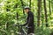 Handsome smiling cyclist looking at camera over forest background