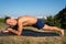 Handsome smiling flexible Athletic man doing yoga asanas in the