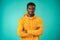 Handsome smiling young african man standing in studio