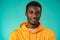 Handsome smiling young african man standing in studio