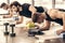 handsome sportsmen simultaneously doing plank and using blocks