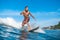 handsome sporty man having fun on surfboard on sunny day during
