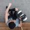 Handsome sporty young man sitting on a wooden step next to a modern white hoverboard. Top view on fashionable guy