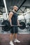 Handsome strong athletic fitness men pumping up arm muscles workout barbell curl fitness concept background - muscular bodybuilder