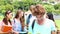 Handsome student smiling at camera with classmates behind