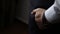 Handsome stylish man dressed in modern formal clothes buttoning jacket. Close up of hands of guy in blue jacket, white