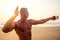 Handsome successful male athlete fitness model photographing selfie portrait on phone beach paradise sunset. man on