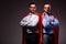 handsome super businessmen in masks and capes standing with crossed arms