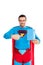 handsome superman pointing with finger at blank box with soap powder and smiling at camera