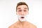 Handsome surprised man with shaving foam on his face