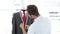 Handsome tailor measuring suit on mannequin