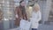 Handsome tall man holding his bicycle talking with pretty blond woman in warm jacket. Positive couple chatting standing