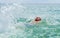 Handsome teen backstroking in the ocean