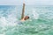 Handsome teen backstroking in the ocean