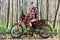 Handsome teen boy sitting on motocross motorbike.