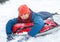 Handsome teen laughing and showing excitement while he slides downhill. snow tubing on winter day outdoors.