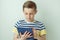 Handsome teen schoolboy standing with tablet and learning