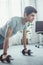 handsome teenager doing push ups with dumbbells