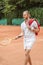 handsome tennis player with retro wooden racket