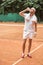 handsome tennis player with towel drinking water