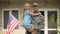 Handsome USA soldier in military uniform holding happy daughter, homecoming