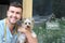 Handsome veterinarian holding Yorkshire Terrier