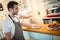 Handsome waiter cleaning counter