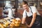 Handsome waiter leaning on a food table