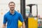 Handsome warehouse worker smiling at camera