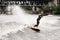 handsome woman in wetsuit engaged in wakeboarding on summer day