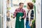 Handsome worker helping a customer with choosing a gardening tool