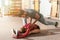 Handsome yoga male personal trainer with a beard helping young fitness girl to stretch her muscles after hard training workout, re