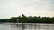 Handsome youmg man swims standing on a kayak