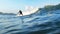 Handsome young adult surfer rides the waves of ocean at the surf spot