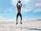 A handsome young african american male athlete working out on the beach. Dedicated black man exercising with a medicine