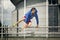 Handsome young athlete jumping over the fence