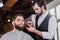 handsome young barber shaving man