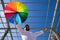 Handsome young blue eyed gay man with open arms holding a rainbow coloured umbrella in his hand. The photo is taken from below and