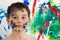 Handsome young boy daubed with colorful paint