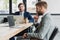 handsome young businessmen in suits using laptops and working together