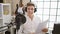 Handsome young caucasian man, a confident news reporter, speaking on-air, reading document in radio studio, nailing the broadcast